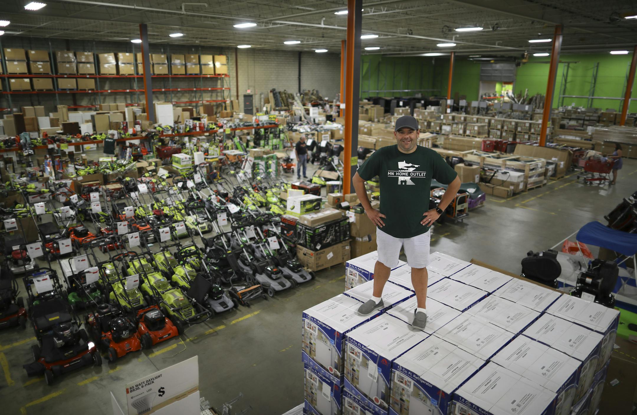 MN Home Outlet owner Jimmy Busika photographed atop a stack of dorm refrigerators in his vast Burnsville warehouse location. ] JEFF WHEELER &#xef; jeff.wheeler@startribune.com MN Home Outlet in Burnsville opened in 2015 as the go-to place for the home remodeler on a tight budget. They claim to be the only retailer in the Twin Cities taking returns and overstocks from major home improvement retailers and reselling them at reduced prices. MN Home Outlet owner Jimmy Busika was photographed in his v