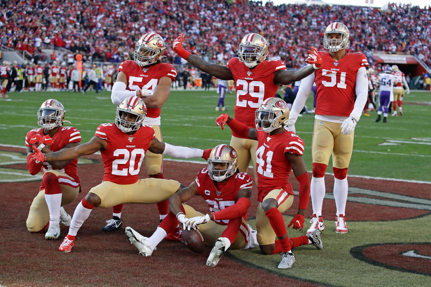 San Francisco 49ers players celebrate as a group after cornerback Richard Sherman (25), bottom center, intercepted a pass after Adam Thielen ran a bad route in the third quarter.