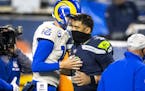 Los Angeles Rams quarterback Jared Goff (16) and Seattle Seahawks quarterback Russell Wilson (3) shake hands after the Rams' 30-20 win during the Wild