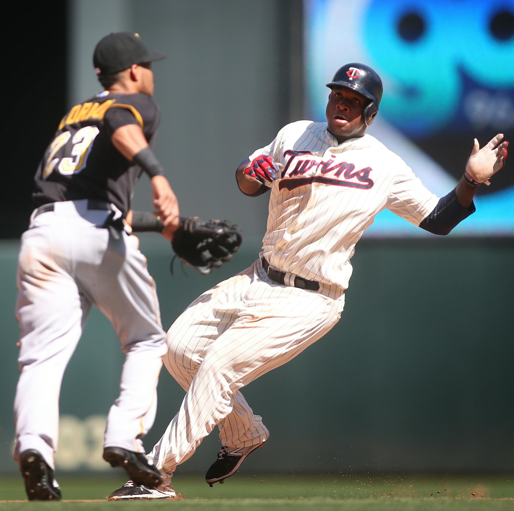 Minnesota Twins designated hitter Miguel Sano (22) over runs second base and is tagged out by Pittsburgh Pirates shortstop Pedro Florimon (23) at Target Field in Minneapolis on Wednesday, July 29, 2015. ] LEILA NAVIDI leila.navidi@startribune.com /