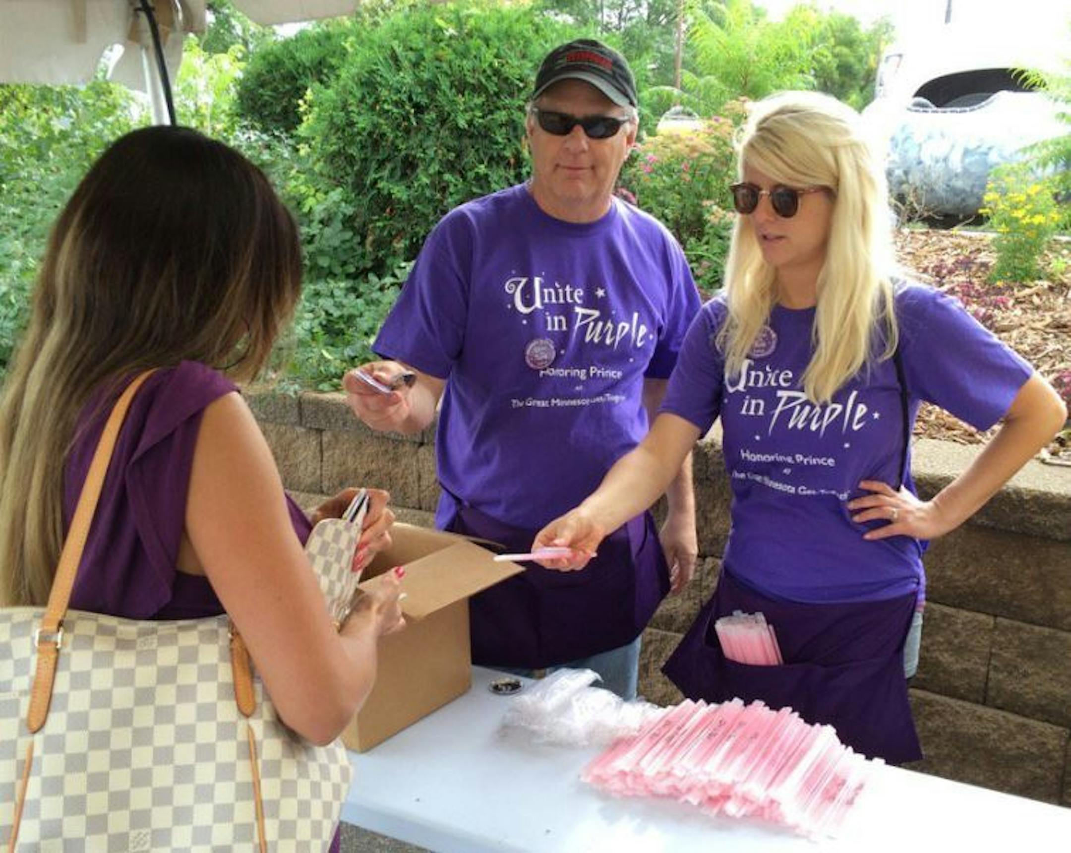Buttons and glow bracelets were being passed out as part of the fair's Prince celebration Friday.