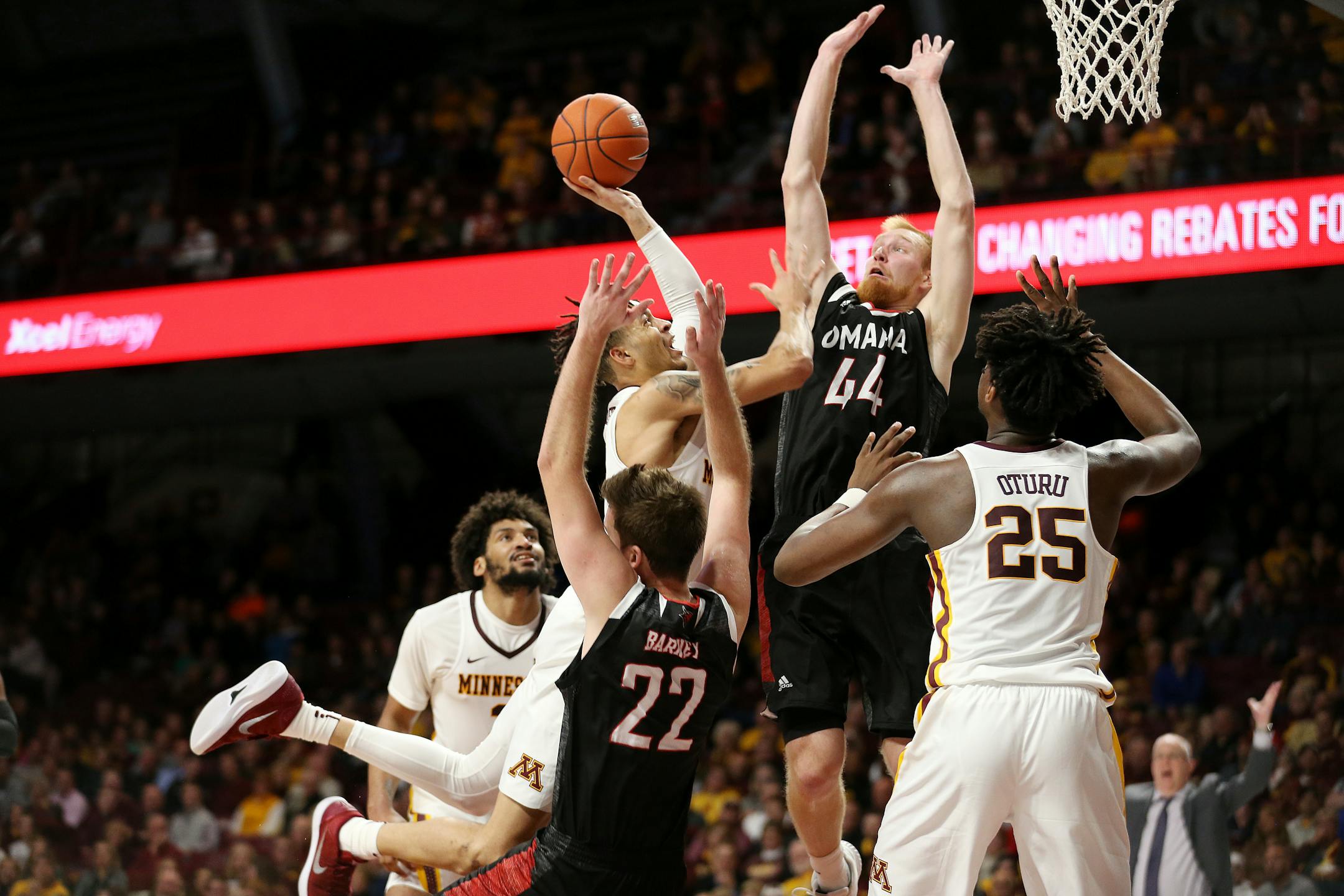 Minnesota's Amir Coffey tries to make a play to the hoop against Omaha's Mitchell Hahn on Tuesday in the season opener at Williams Arena.