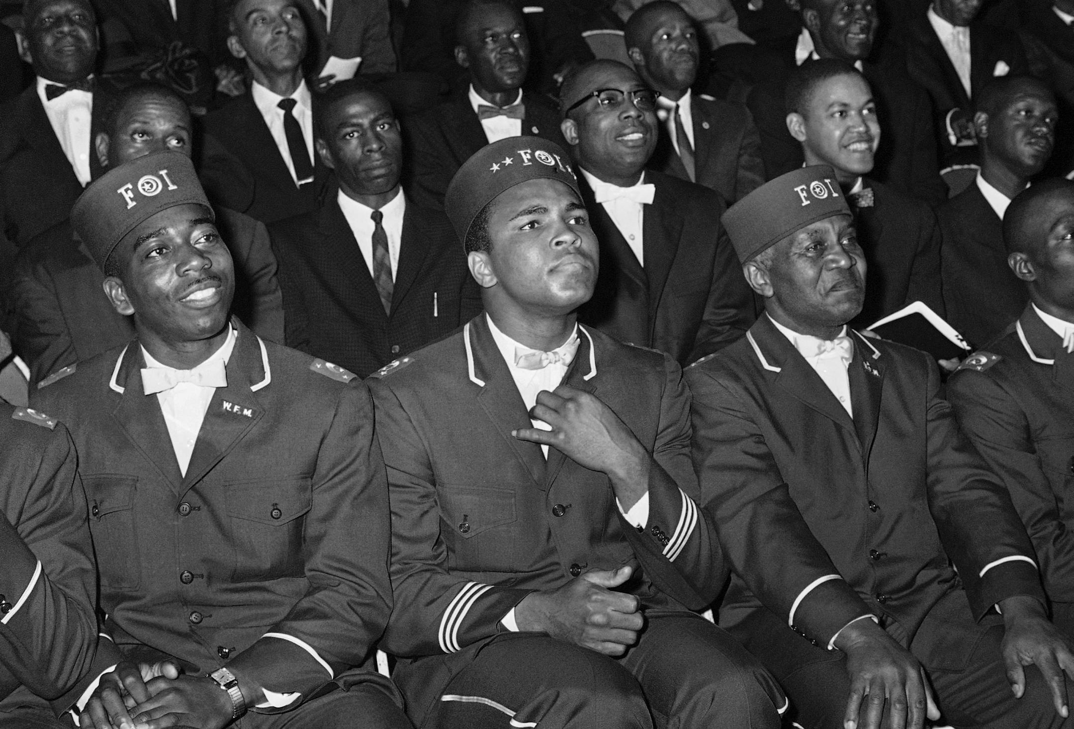 Muhammad Ali listens intently to his leader, Elijah Muhammad as Elijah gave a marathon speech to black Muslims in Chicago, Feb. 28, 1966. The State of Illinois boxing commissioners will rule on the fate of Ali?s fight scheduled on March 29 with Ernie Terrell. (AP Photo/Paul Cannon) ORG XMIT: APHS283430