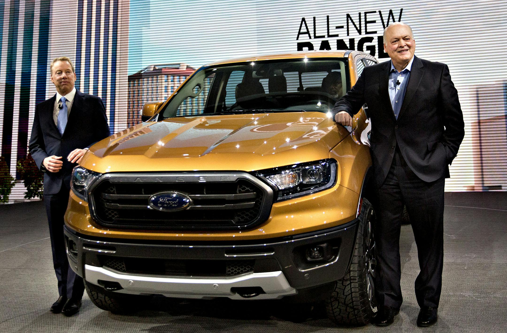 Jim Hackett, president and chief executive officer of Ford (right) and Bill Ford, executive chairman of Ford (left) stand next to a 2019 Ranger mid-size pickup truck at an event during the 2018 North American International Auto Show in Detroit on Jan. 14, 2018. MUST CREDIT: Bloomberg photo by Andrew Harrer.