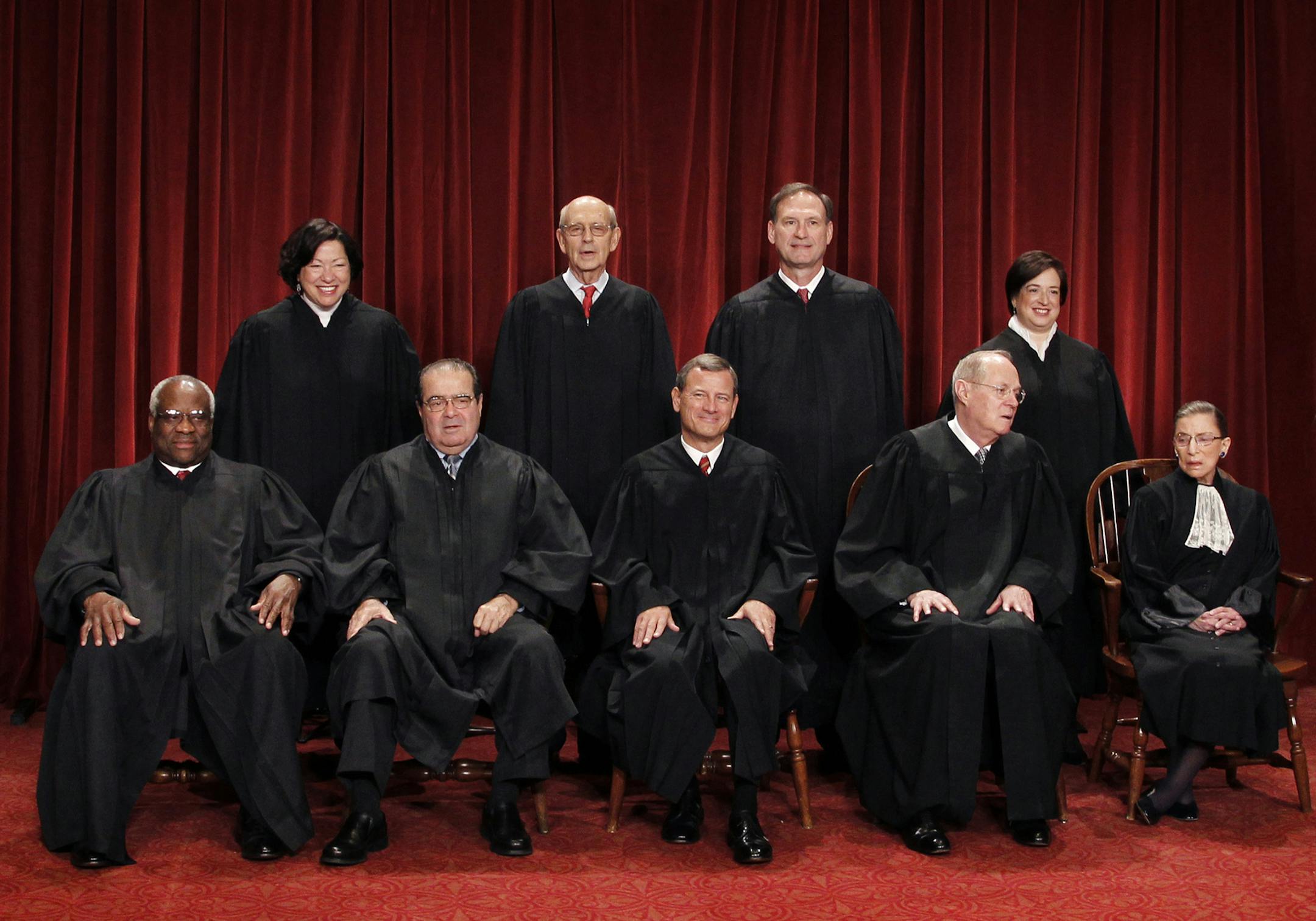 In this photo taken Oct. 8, 2010, the U.S. Supreme Court justices pose for a group photo at the Supreme Court in Washington. Three justices will turn 80 before the next presidential term ends: Associate Justices Ruth Bader Ginsburg, right, who leads the closely divided court's liberal wing, Antonin Scalia, second from left, a conservative, and Anthony Kennedy, second from right, who leans conservative, but on some issues provides a decisive vote for the liberals. A titanic confirmation fight wou
