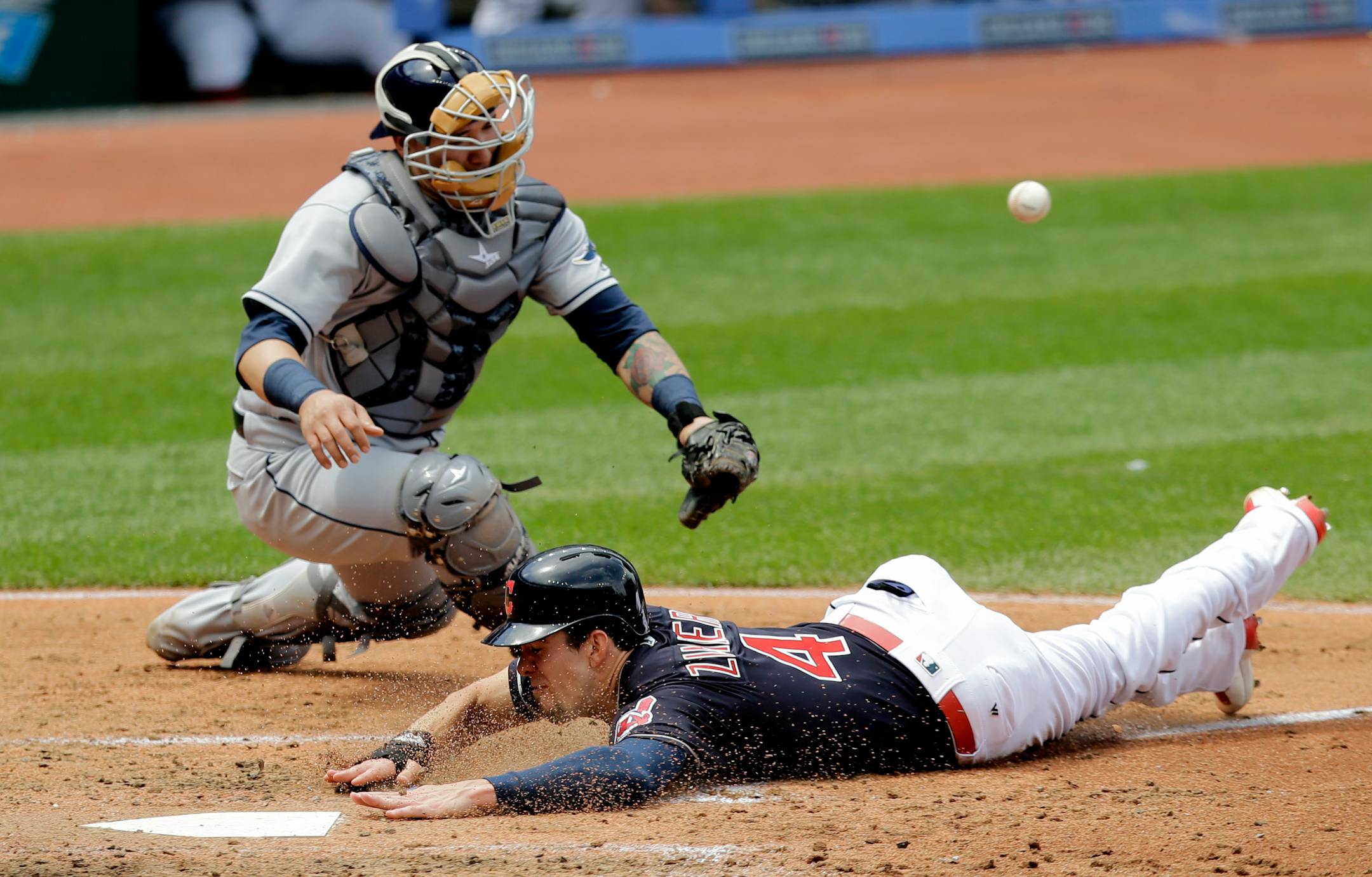 Cleveland Indians' Bradley Zimmer slides safely into home plate as Tampa Bay Rays catcher Jesus Sucre can't hold onto the ball in the third inning of a baseball game, Wednesday, May 17, 2017, in Cleveland. Zimmer scored on Jason Kipnis's single. (AP Photo/Tony Dejak)