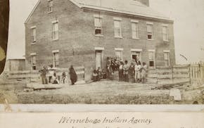 sepia-toned photo depicts people standing in front of a building prior to 1863