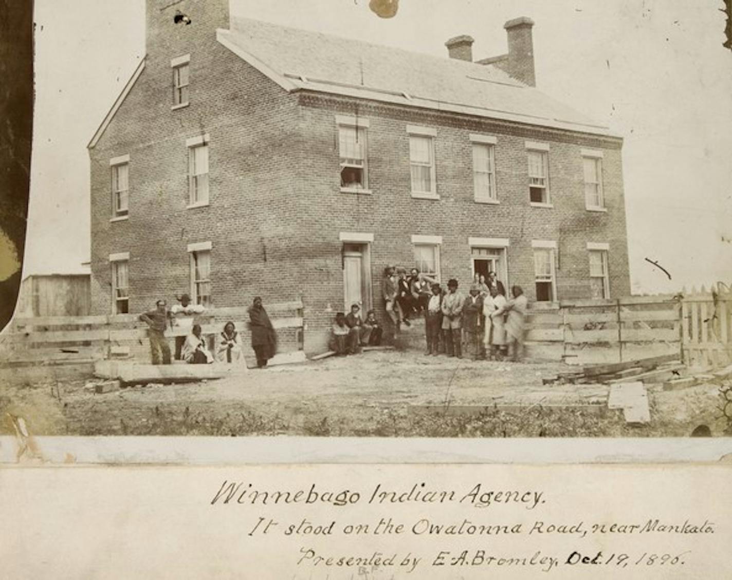 sepia-toned photo depicts people standing in front of a building prior to 1863