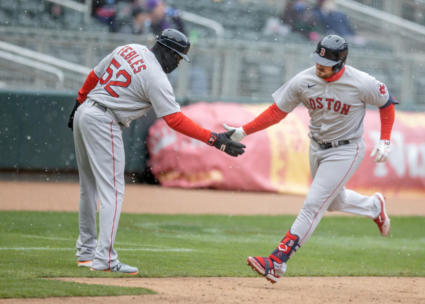 Boston's Hunter Renfroe celebrated with third base coach Carlos Febles after hitting a home run during the fifth inning Tuesday