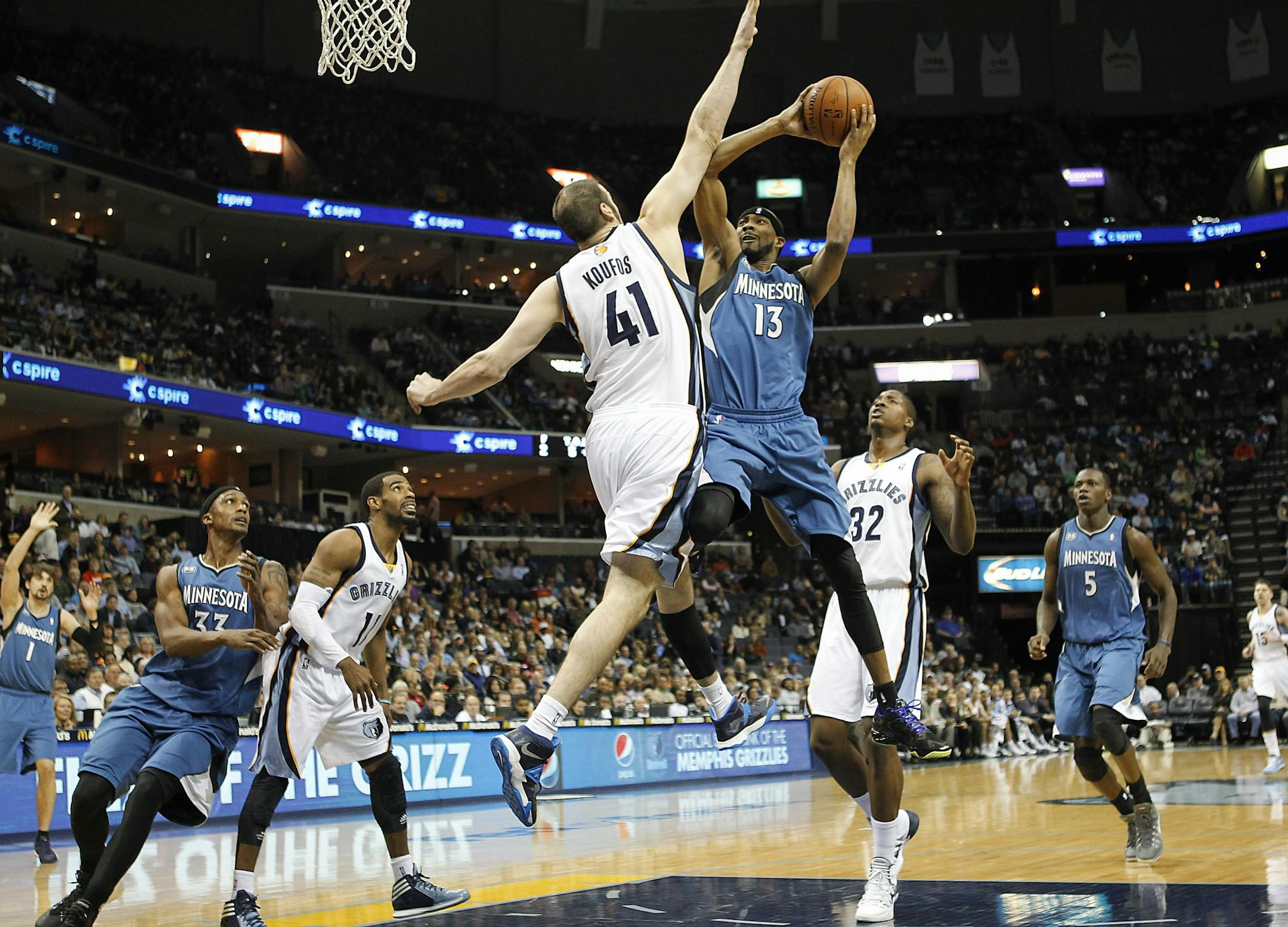 Timberwolves forward Corey Brewer (13) went to the basket against Grizzlies center Kosta Koufos in the first half Monday.