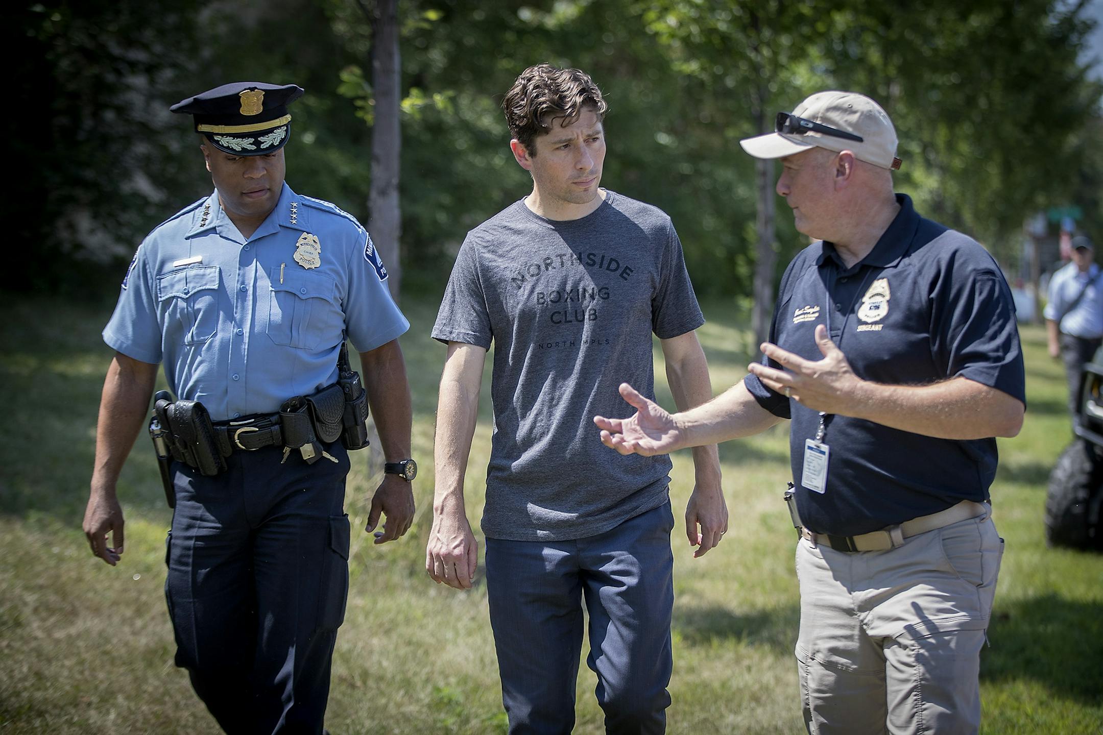 Minneapolis Police Chief Medaria Arradondo, left, Minneapolis Mayor Jacob Frey, center, and Minneapolis Police Sgt. Grant Snyder, right, visited a homeless encampment near 16th Avenue South & East Franklin Avenue Wednesday, August 8, 2018 in Minneapolis, MN.