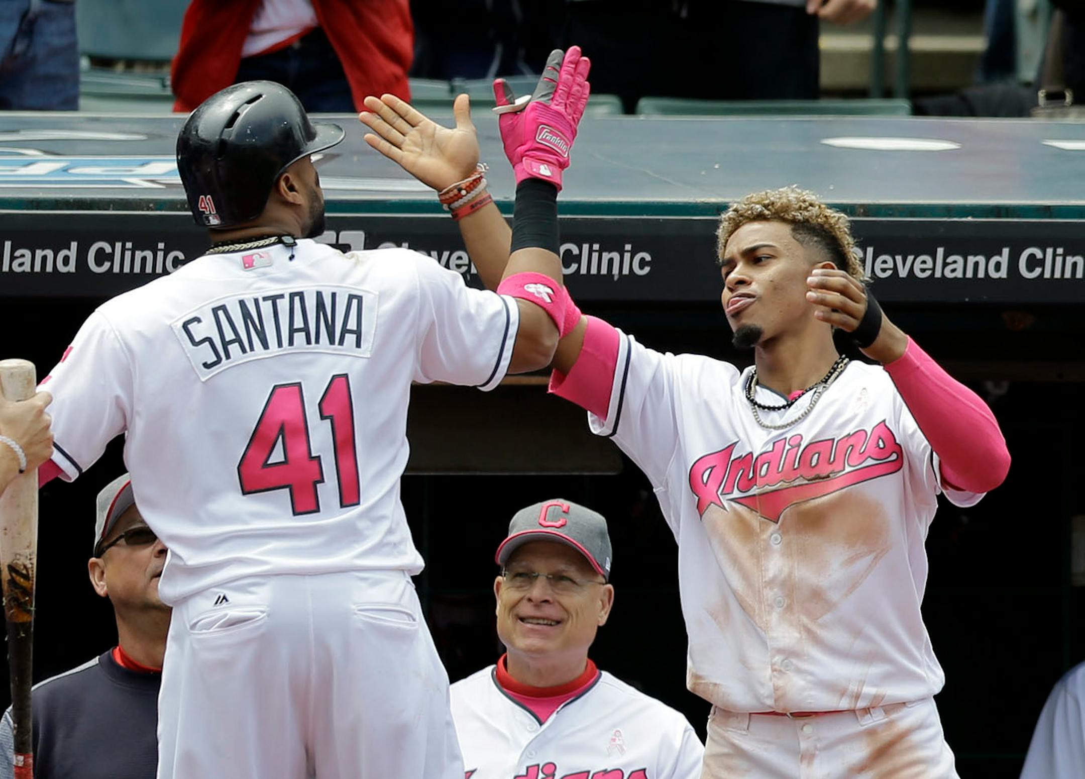 Cleveland Indians' Carlos Santana, left, is congratulated by Francisco Lindor after Santana hit a solo home run off Minnesota Twins' Hector Santiago in the third inning of a baseball game, Sunday, May 14, 2017, in Cleveland.