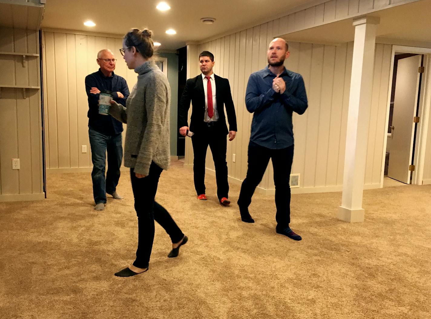 First-time home buyers, Matt and Kate Shalbrack (second from left and far right), inspect the lower level of a house they want to buy with Keller Williams sales agent, Nick George (second from right), and Kate&#x2019;s father, Sheldon Matheson (far left)