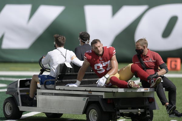 San Francisco 49ers defensive end Nick Bosa (97) is driven off the field after being injured during the first half of an NFL football game against the