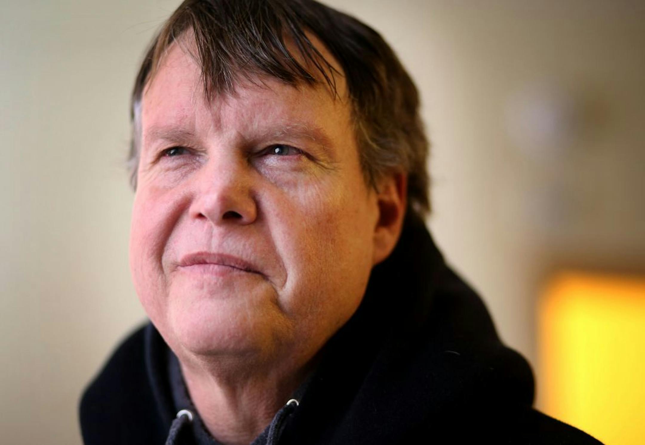 Brad Teslow, a former gym teacher, pauses at his apartment before heading to work Wednesday, Feb. 27, 2016, in St. Paul, MN.