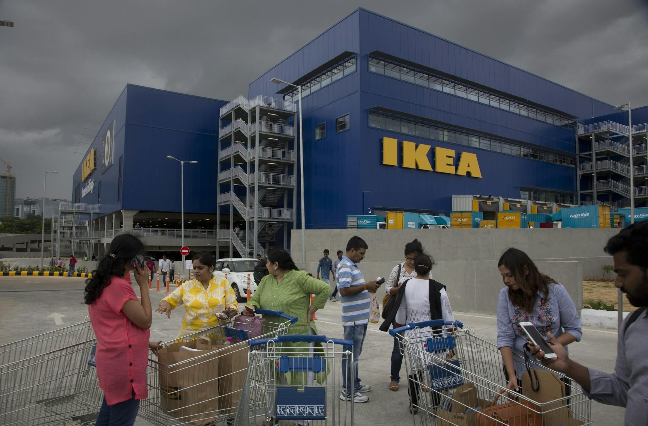 FILE- In this Aug. 9, 2018, file photo, Customers stand outside Ikea's first store in India as it opened in Hyderabad, India. India is a test case for whether Ikea should keep shifting resources toward emerging economies, including Latin America and China, given the saturation of markets in Europe and the United States, and the possibility of another global recession. Six months after Ikea opened its first store in Hyderabad, the 400,000-square-foot cornucopia of furniture, linens, kitchenware a
