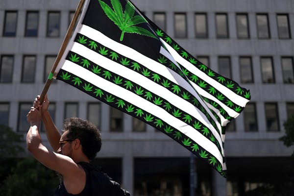 A marijuana activist holds a flag during a march in Washington, D.C., in 2021.