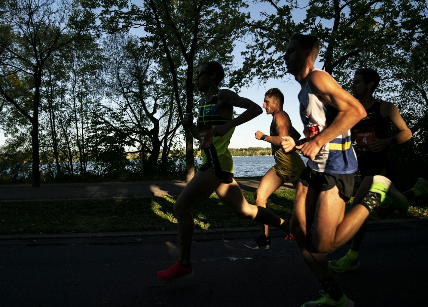 The men's leaders ran past Lake Harriet in the morning light at almost mile 8 during the 2019 Medtronic Twin Cities Marathon in Minneapolis, Minn., on Sunday, October 6, 2019.