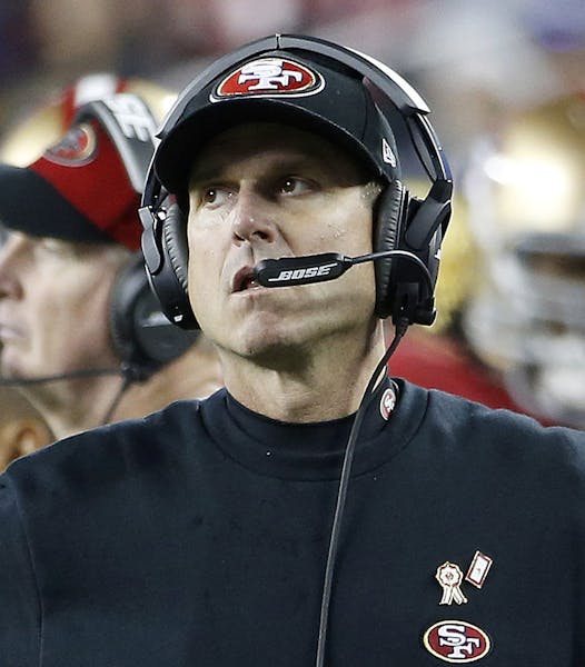 FILE - In this Nov. 27, 2014, file photo, San Francisco 49ers head coach Jim Harbaugh stands on the sideline during the fourth quarter of an NFL footb