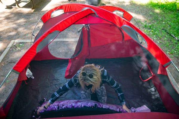 Meghan Wellner unpacked her bedding inside her tent at her campsite at Jay Cooke State Park in Carlton, Minn.