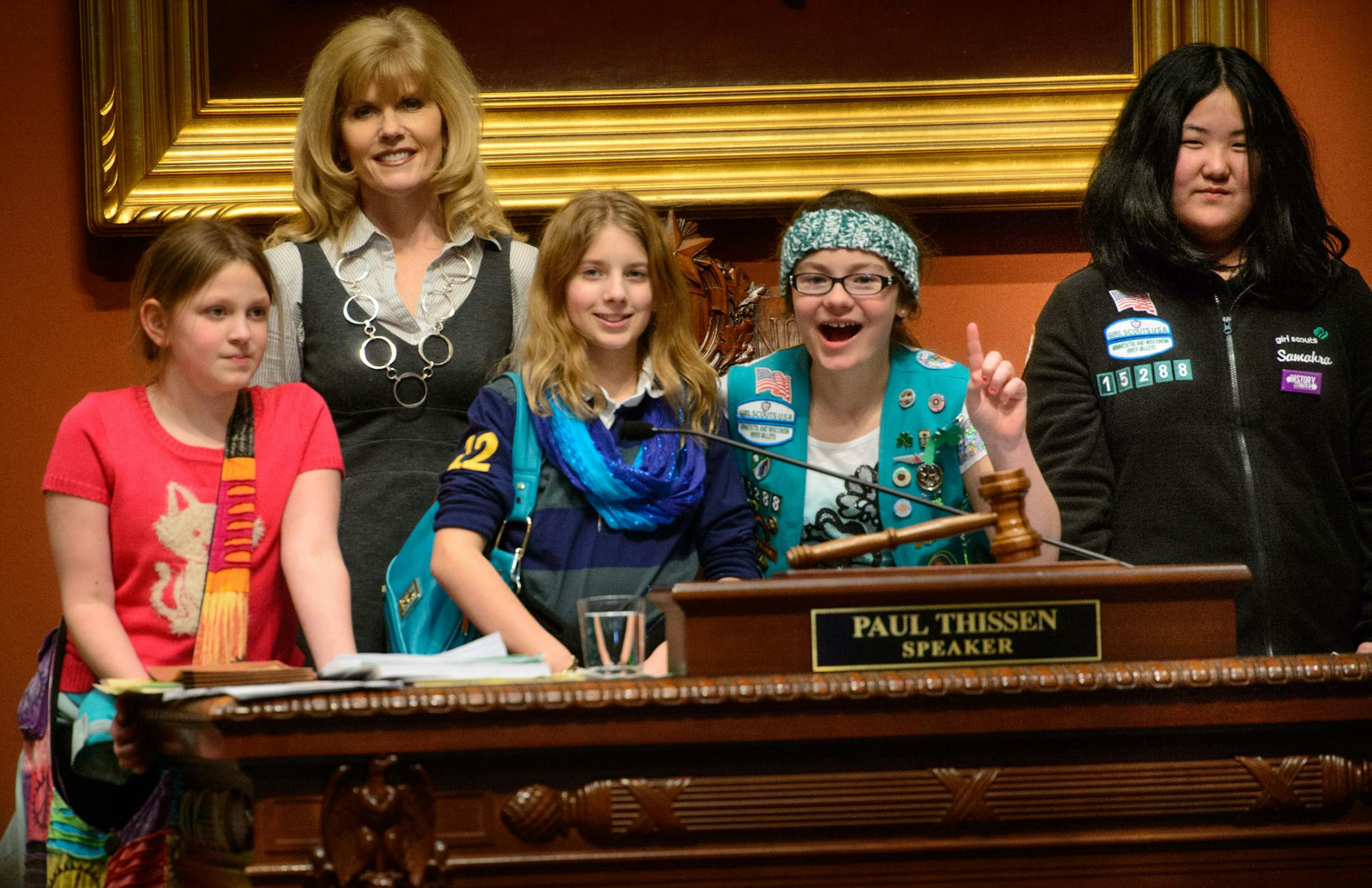 Below: From left to right, Macy Bernard, Bridget McNess, Lainey Donoghue and Samahra Sprague of the Anoka-Ramsey Girl Scout troop 15288 visited their district’s representative, Peggy Scott, R-Andover, and got to have their photo in the speaker’s seat before the start of Monday’s session. They were working to earn their government-in-action badge.
