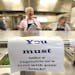 A sign is posted telling students to take a vegetable or fruit with their lunch at Wingate Elementary School, May 29, 2014 in Wingate, Pa. District of