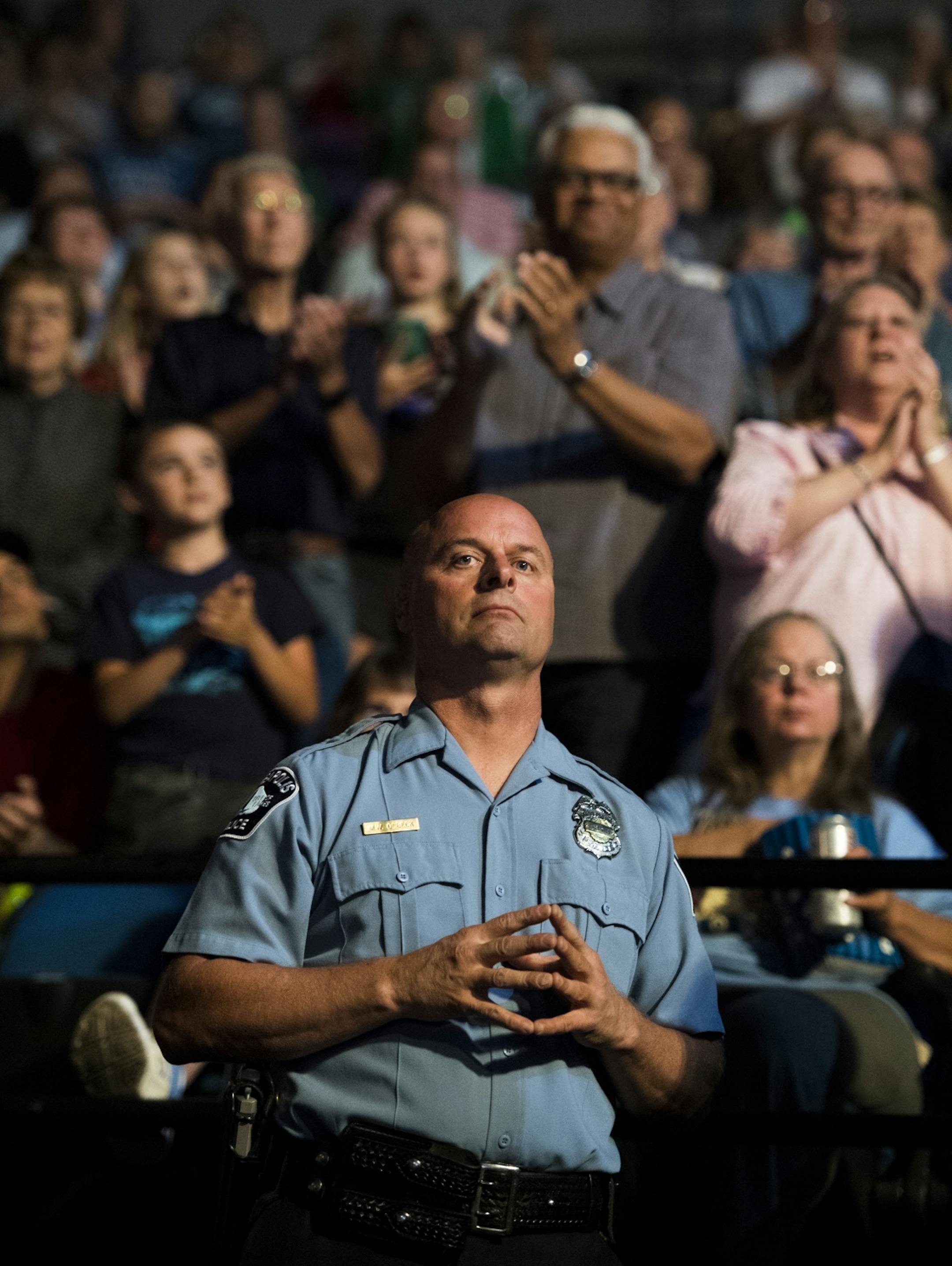 Minneapolis police officer Michael Osbeck looked towards the court as the Lynx's starting lineup is announced.