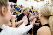 New London-Spicer head coach Mike Dreier, center, cracks a smile during the final timeout before his team defeated Watertown-Mayer on Friday, Jan. 28,