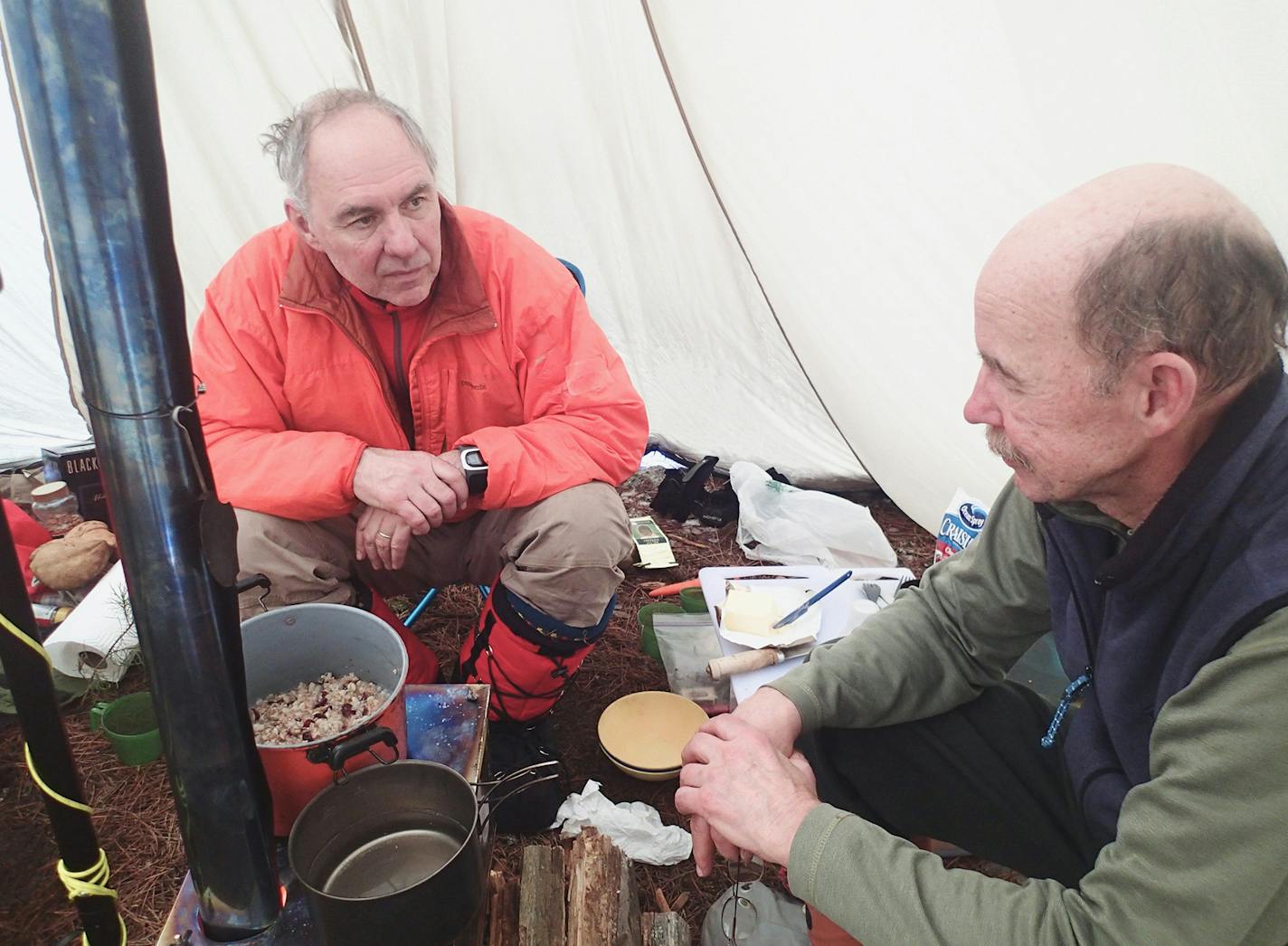 Steve Piragis, left, and a friend huddle in their tepee in the Boundary Waters Canoe Area Wilderness.