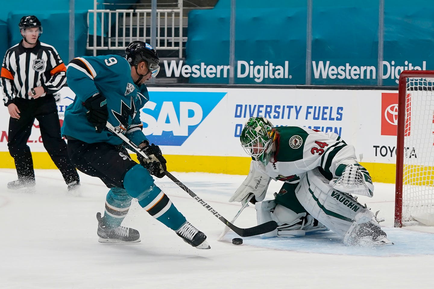 Minnesota Wild goaltender Kaapo Kahkonen (34) defends a shot attempt by San Jose Sharks left wing Evander Kane (9) during the first period of an NHL hockey game in San Jose, Calif., Wednesday, March 31, 2021. (AP Photo/Jeff Chiu)