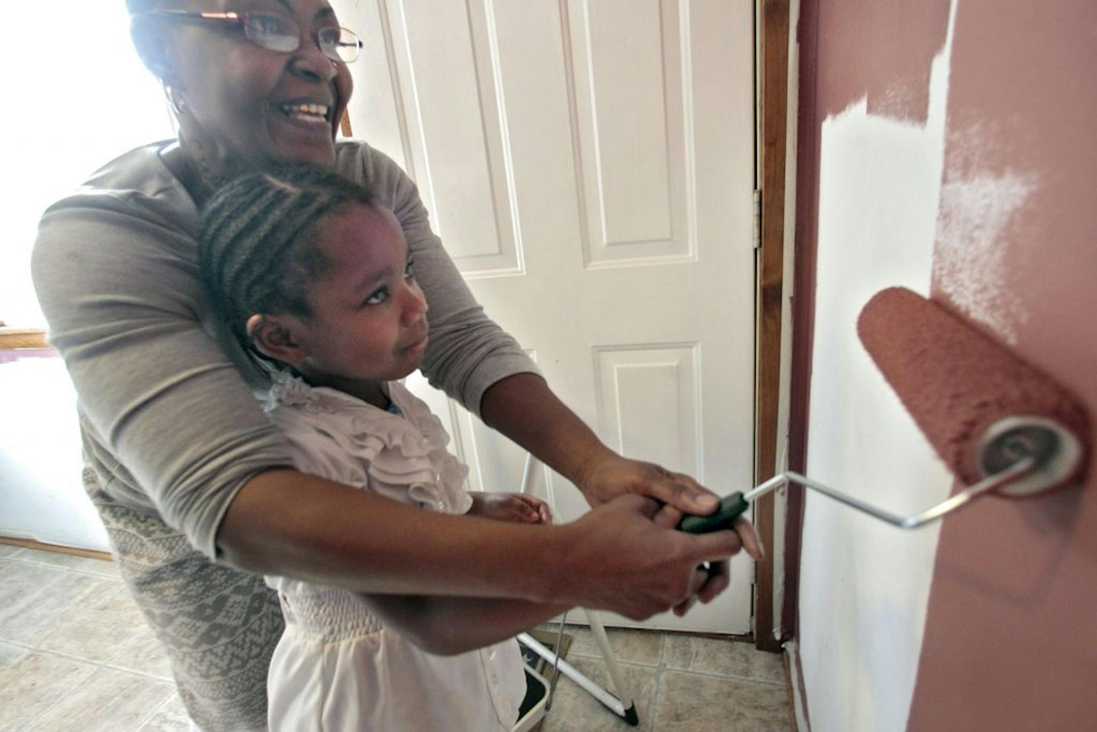 Homeowner Deann Gayles painted her kitchen with a little help from granddaughter Eryca Walker, 5.