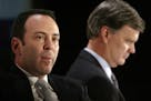 Kmart chairman Edward Lampert, left, and Sears CEO Alan Lacy listen during a news conference to announce the merger of Kmart and Sears in New York Wed