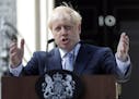 FILE - In this file photo dated Wednesday, July 24, 2019, Britain's newly installed Prime Minister Boris Johnson gestures as he speaks outside 10 Down