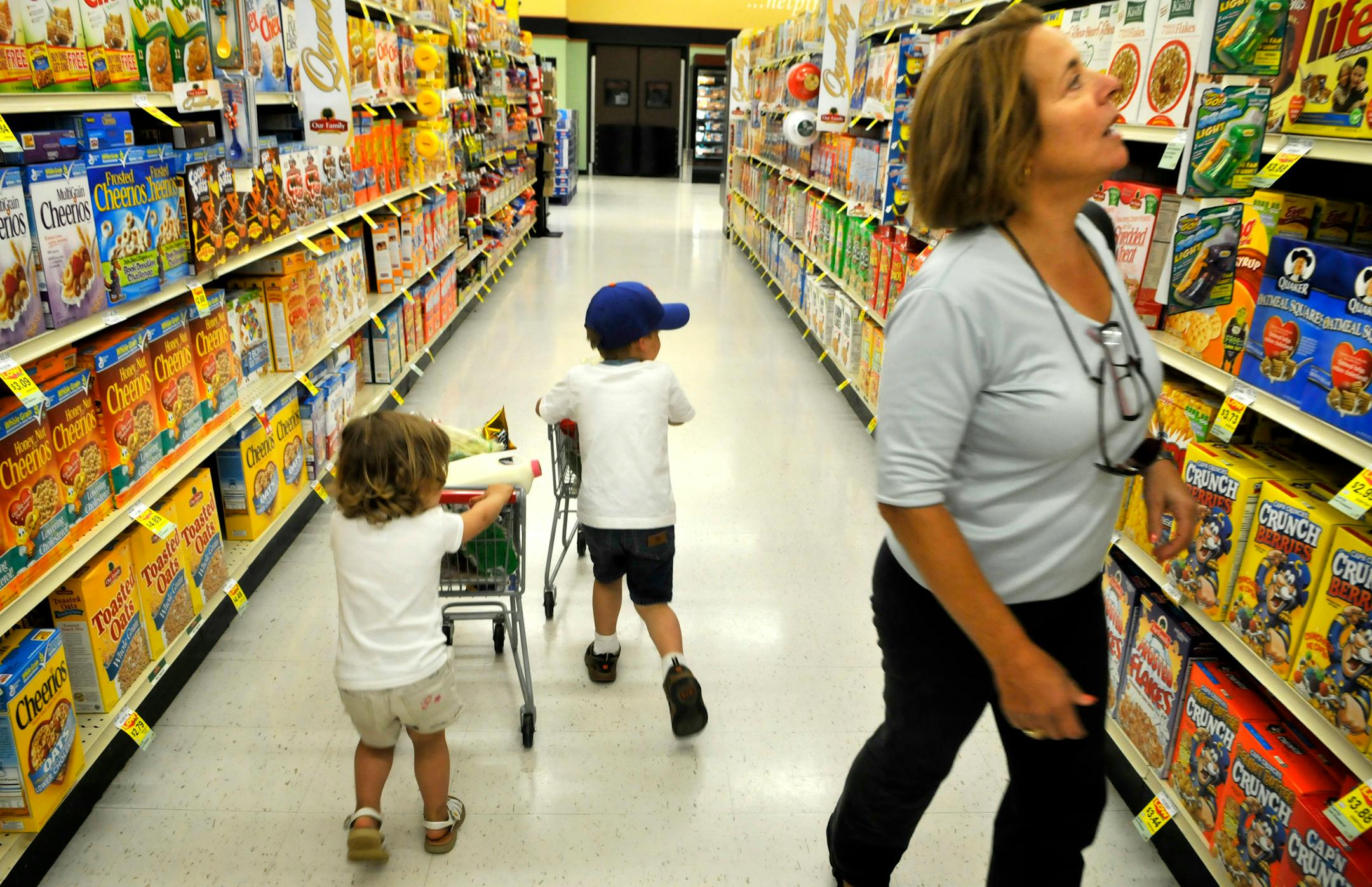With her grandchildren, Hillary and Patrick Heitz, pushing their kid-sized carts, Jeanne Riley shopped the new Family Fresh Market in Hudson, Wis. The store emphasizes its "Well Balanced" approach.