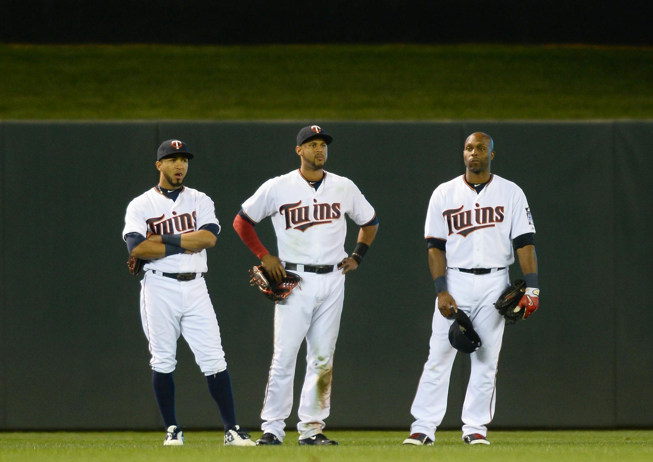 From left, Minnesota Twins left fielder Eddie Rosario (20), center fielder Aaron Hicks (32) and right fielder Torii Hunter (48) all looked on as relief pitcher Glen Perkins (15) was replaced by Trevor May on Friday.