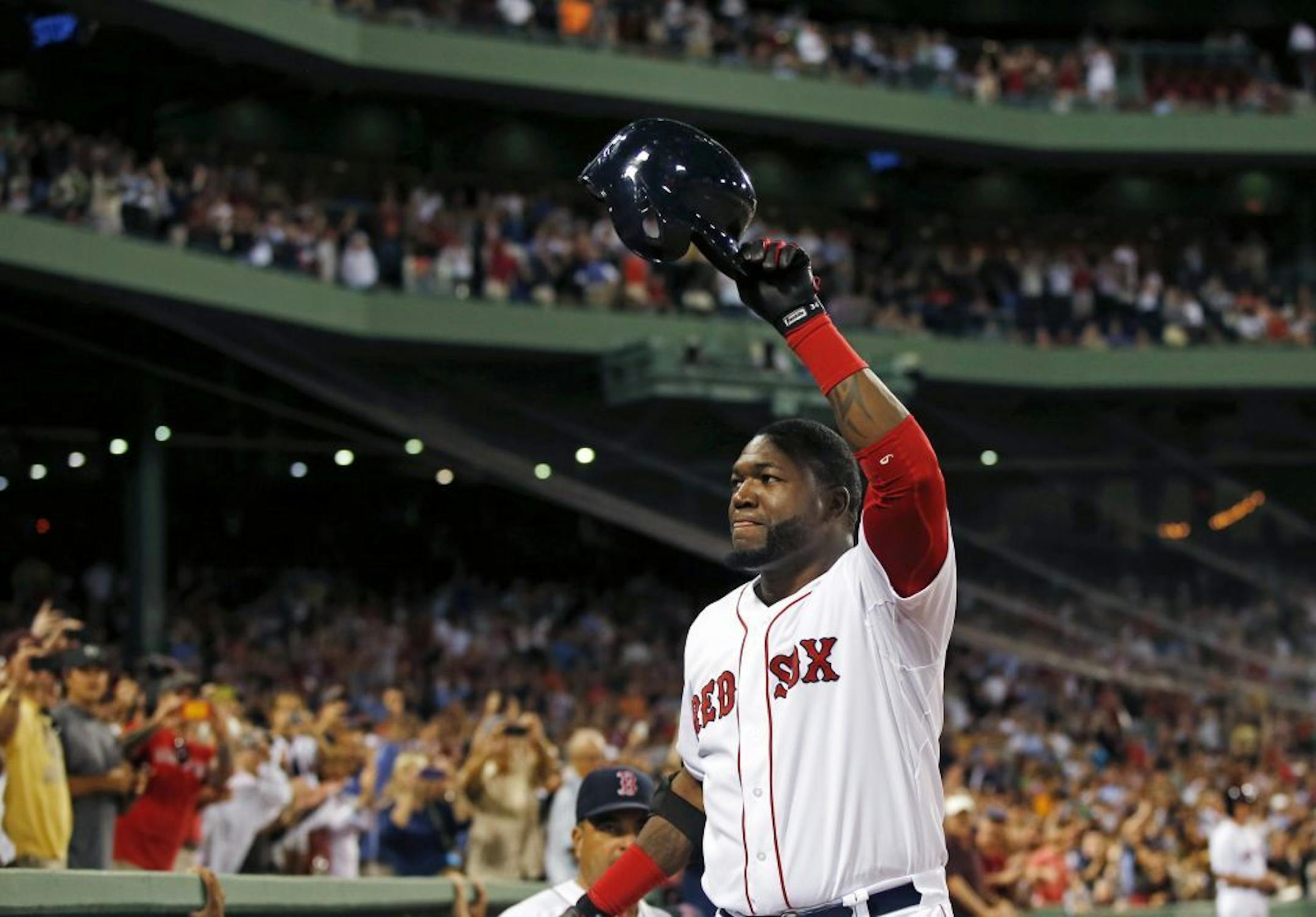 Boston Red Sox designated hitter David Ortiz comes out of the dugout and tips his cap to the fans after hitting his second home run in the game for his 2001th career hit in the seventh inning of a baseball game against the Detroit Tigers at Fenway Park in Boston, Wednesday, Sept. 4, 2013.