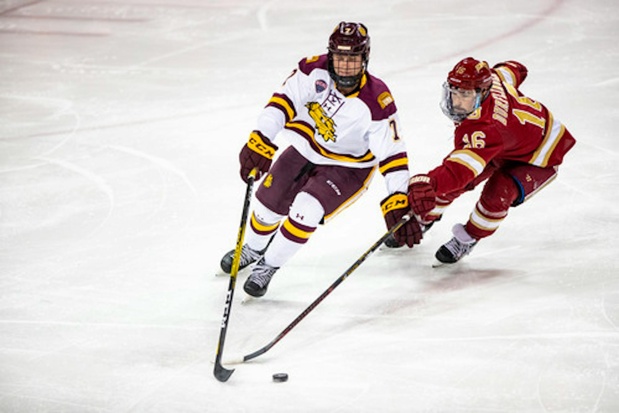 Defenseman Scott Perunovich,left, helped Minnesota Duluth win back-to-back national championships.