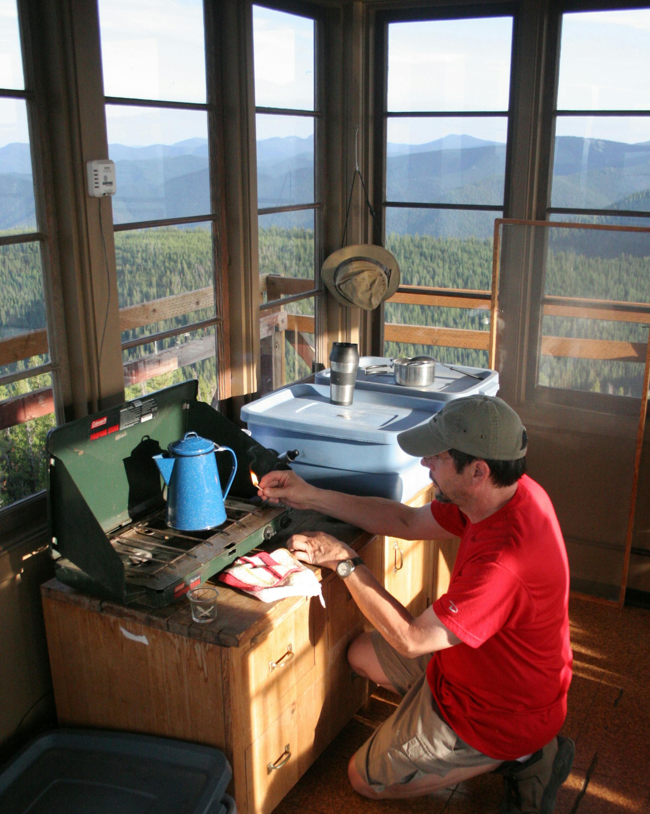 IMG4588: Phil lights a cook stove in Up Up Lookout Tower on the Lolo National Forest in Montana.