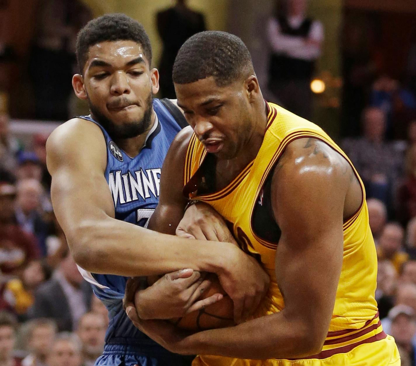 Timberwolves center Karl-Anthony Towns, left, and Cleveland's Tristan Thompson battled for the ball in the first half Monday night.