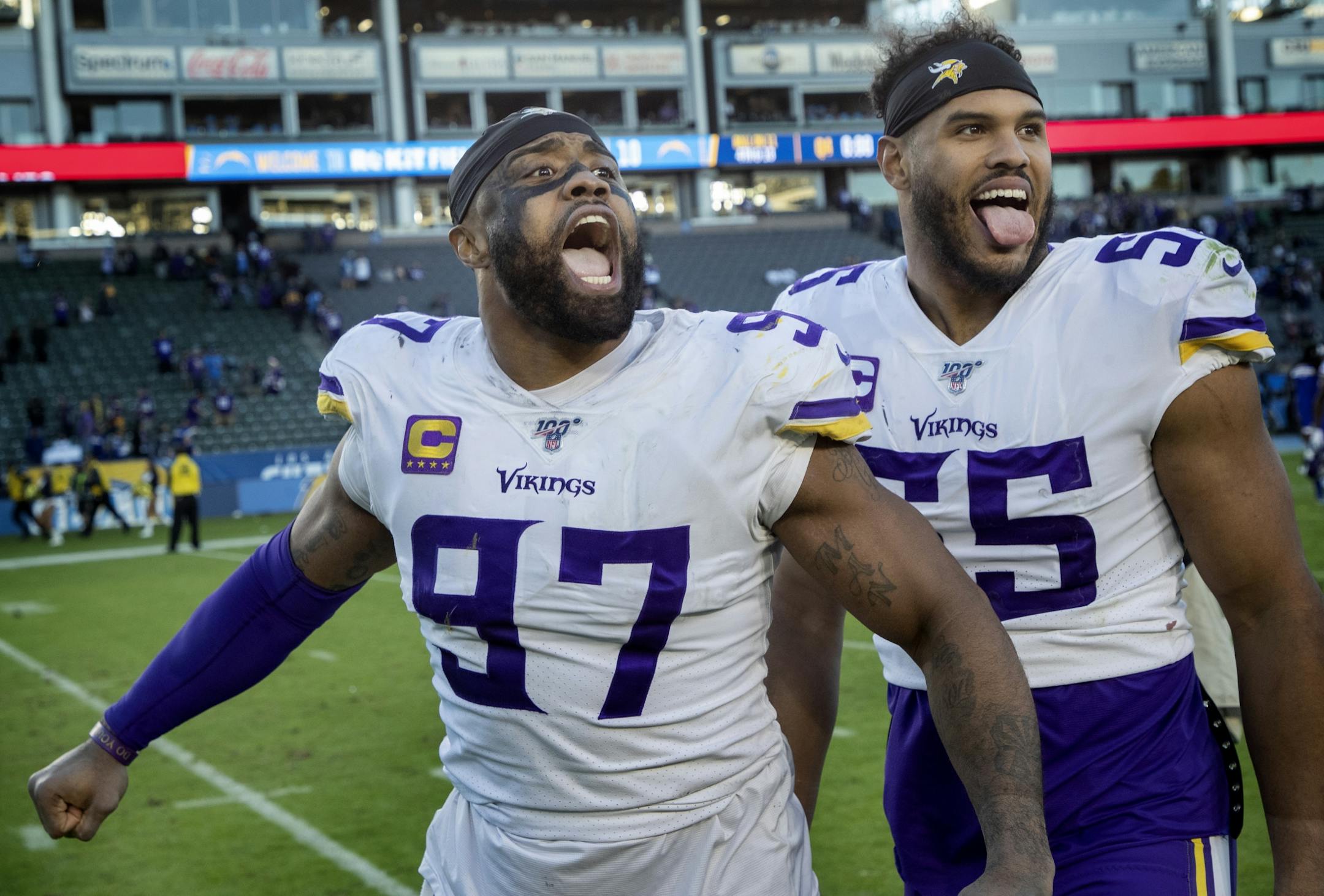 The Vikings' Everson Griffen (97) and Anthony Barr (55) celebrated at the end of the game after defeating the LA Chargers.