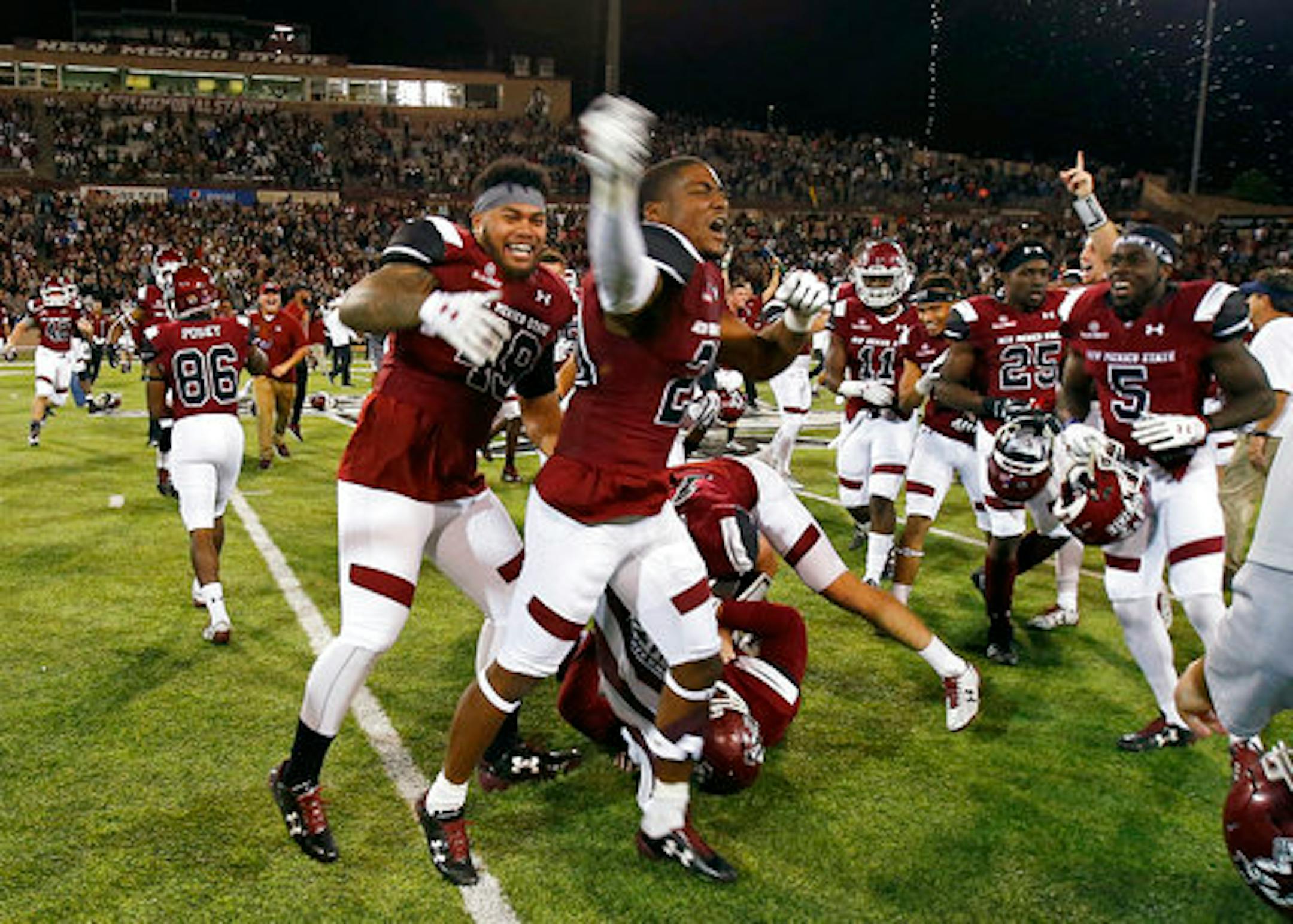 New Mexico State players celebrate the team's 22-7 over South Alabama in an NCAA college football game in Las Cruces, N.M., Saturday, Dec. 2, 2017. (AP Photo/Andres Leighton)