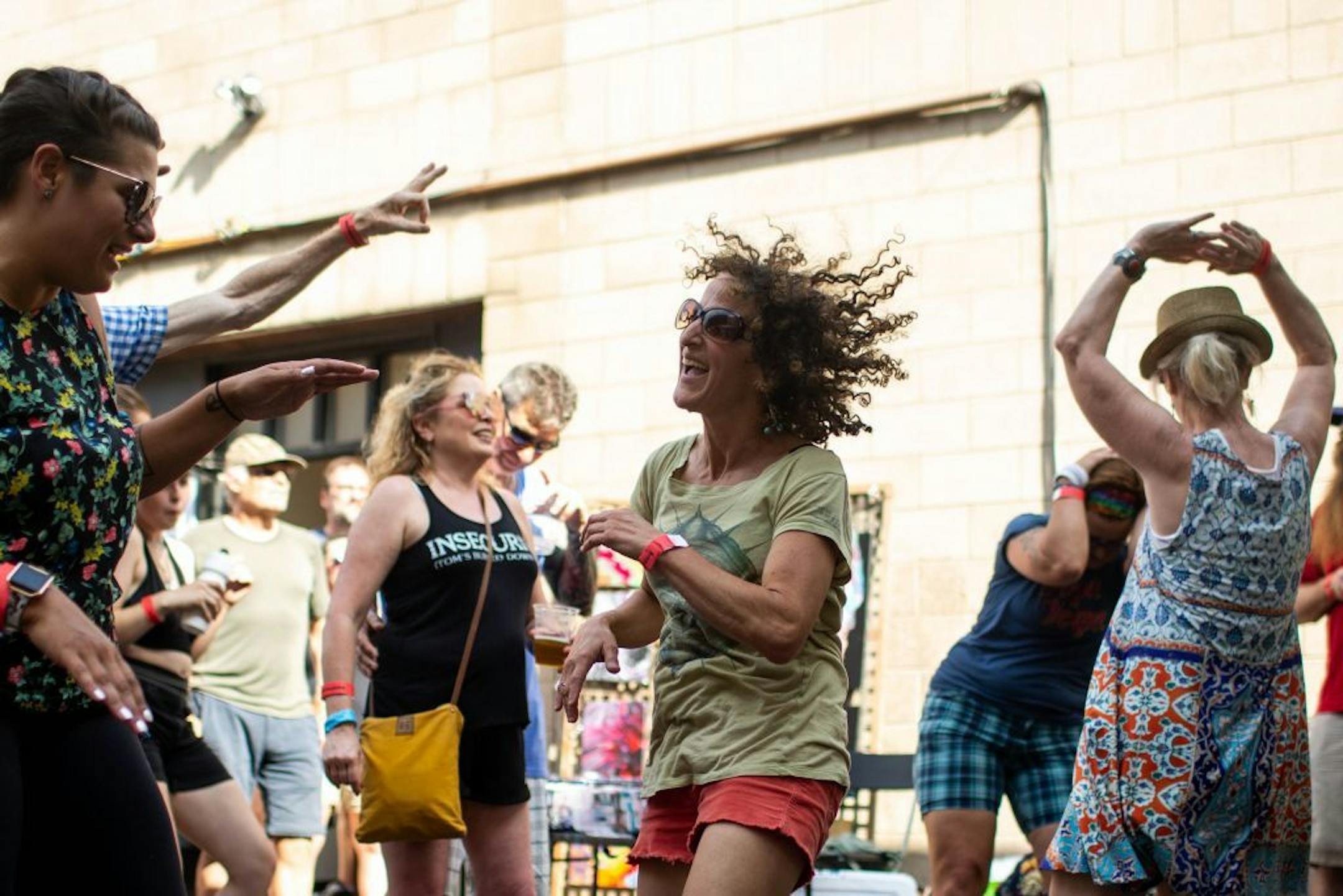 Judy Atrubin (center) dances with others as Mae Simpson performs at the Jameson Main Stage.