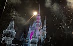 Cinderella&#x2019;s Castle glows during the finale of the nightly light show in the Magic Kingdom.