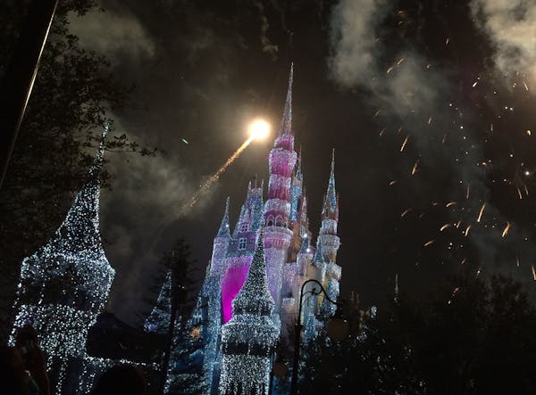 Cinderella&#x2019;s Castle glows during the finale of the nightly light show in the Magic Kingdom.