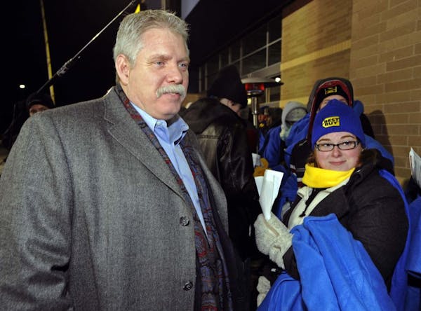 FILE -- Nov. 2010: In this photograph taken by AP Images for Best Buy, Brian Dunn greets shoppers waiting for the Eden Prairie Best Buy to open for Bl