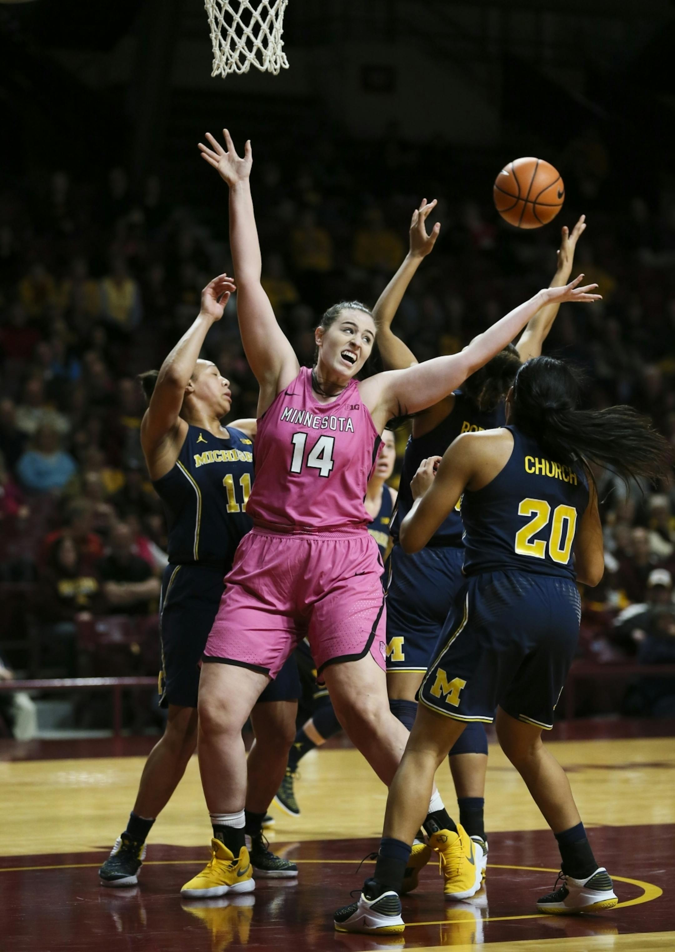 Minnesota Golden Gophers center Bryanna Fernstrom (14) reached for a rebound in the first half