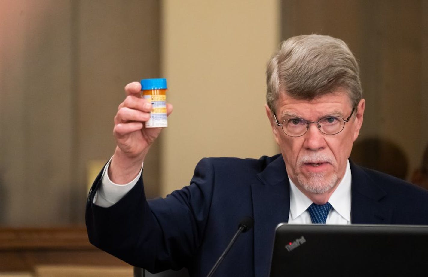 Legislative Auditor James Nobles held up a bottle of his own blood pressure medication explaining that no one should pay for him to take his own medication at home as they did in the case he investigated into Medicaid overpayments by the state Department of Human Services (DHS) to Indian bands for opioid addiction treatment.