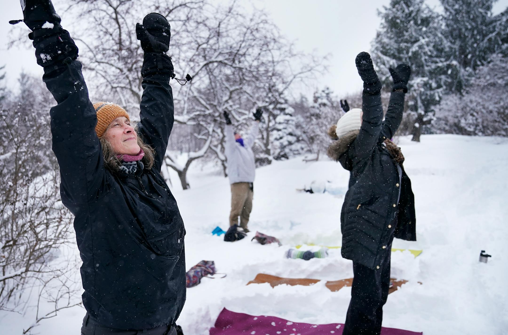 Snowga participant Liz Kelliher strikes a pose at the Lilac Walk in the Minnesota Landscape Arboretum.