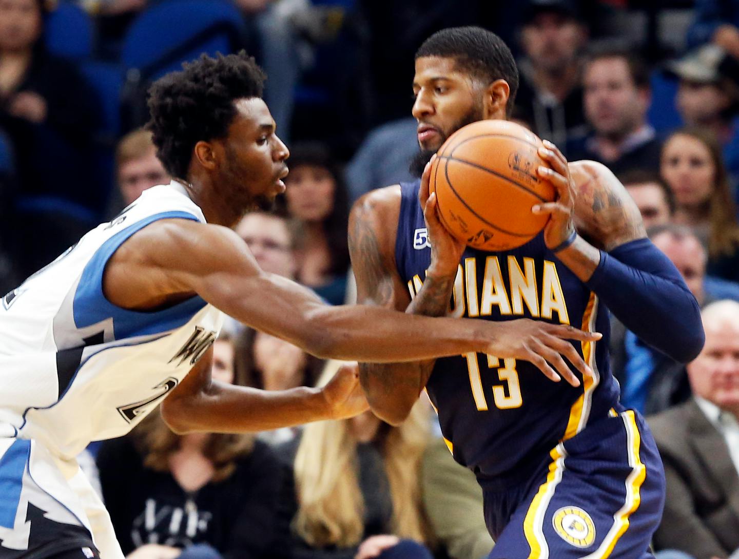 Indiana Pacers' Paul George, right, drives as Minnesota Timberwolves' Andrew Wiggins defends during the first quarter of an NBA basketball game Thursday, Jan. 26, 2017, in Minneapolis. (AP Photo/Jim Mone)