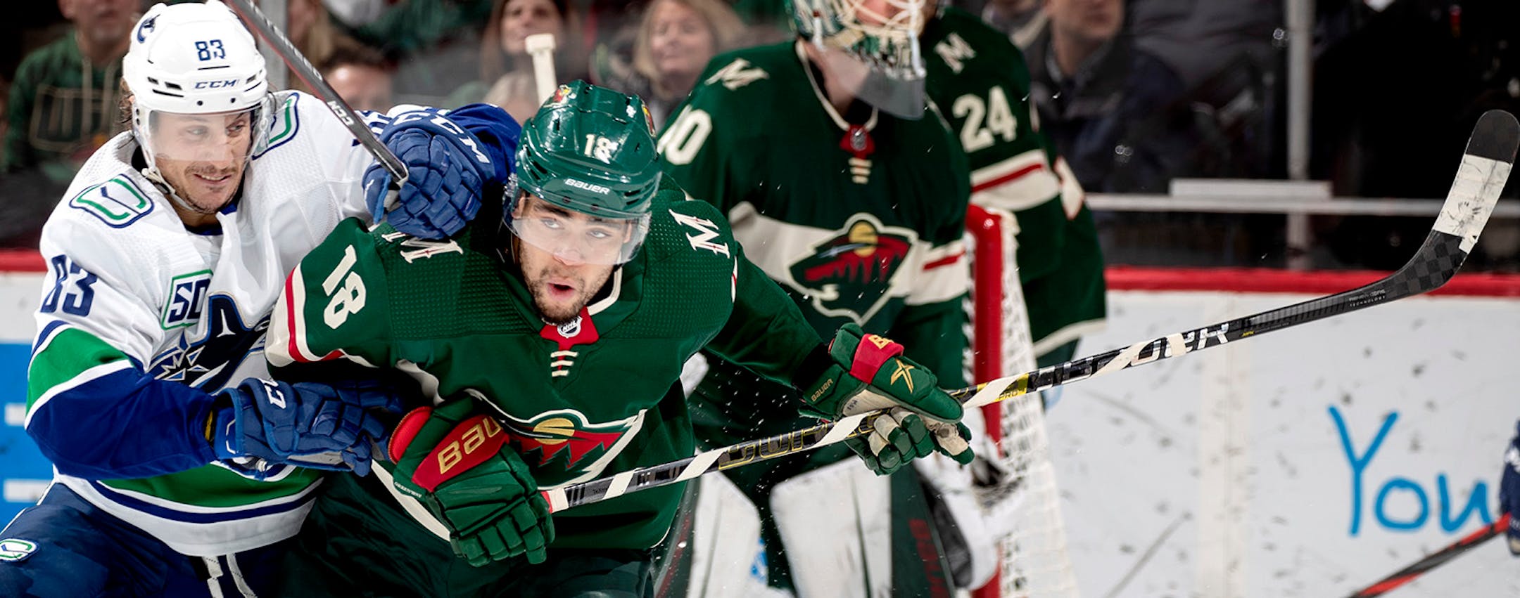 Jay Beagle (83) of the Vancouver Canucks and Jordan Greenway (18) of the Minnesota Wild chased the puck in the second period.